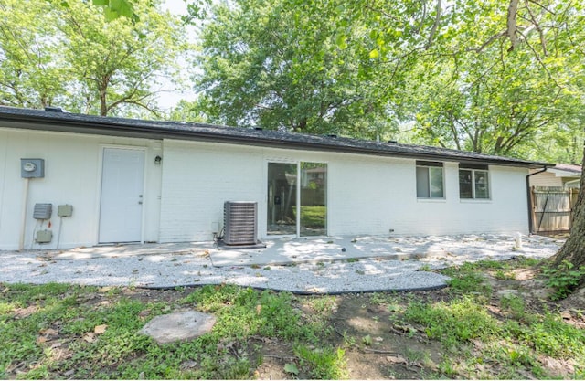 3218 W Countryside Dr, Springfield, MO 65807 - back of property featuring a patio area, central air condition unit, and brick siding