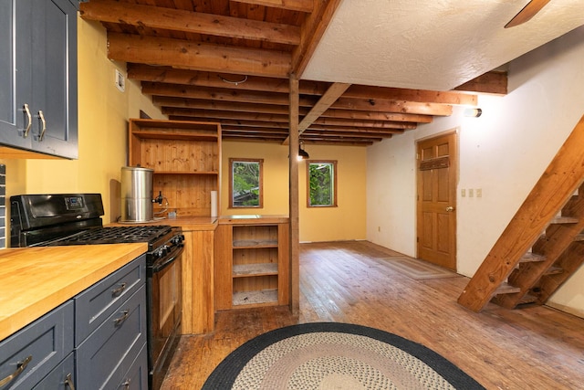 12234 Co Rd Unit 76-269, Ava, MO 65608 - kitchen with black gas range oven, wood counters, beam ceiling, light wood-style floors, and gray cabinets