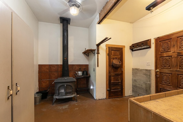 12234 Co Rd Unit 76-269, Ava, MO 65608 - basement featuring a wood stove, a ceiling fan, and a wainscoted wall