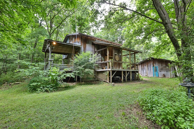 12234 Co Rd Unit 76-269, Ava, MO 65608 - rear view of house with a yard, an outbuilding, and a wooden deck