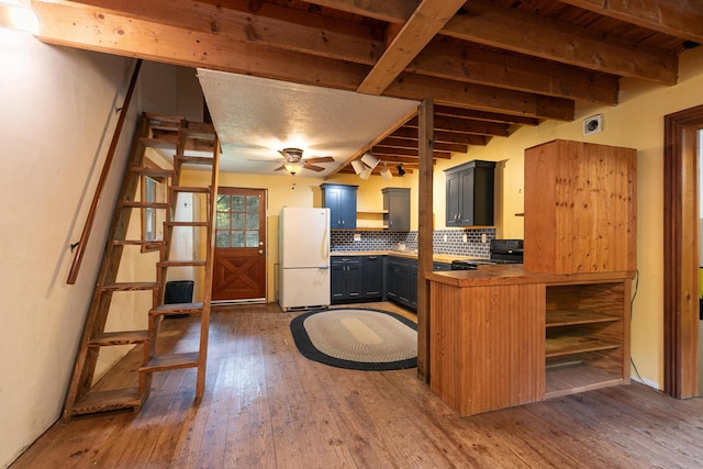 12234 Co Rd Unit 76-269, Ava, MO 65608 - kitchen with freestanding refrigerator, black range oven, hardwood / wood-style flooring, beam ceiling, and tasteful backsplash