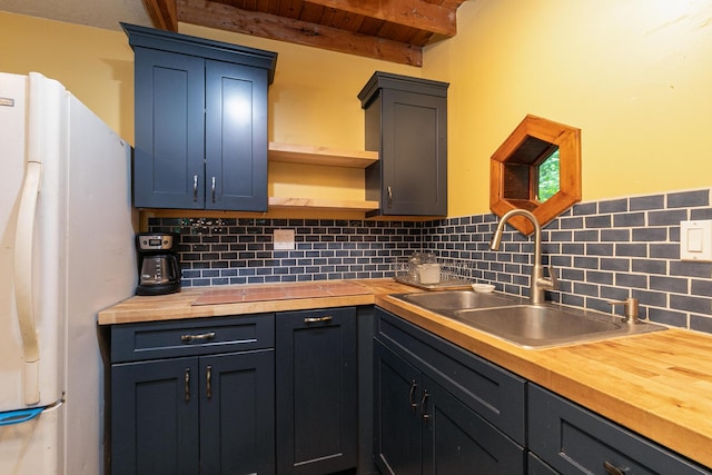 12234 Co Rd Unit 76-269, Ava, MO 65608 - kitchen featuring butcher block counters, freestanding refrigerator, open shelves, wood ceiling with exposed beams, and a sink