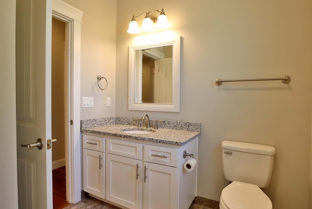 1189 N Cedar Ridge Ave, Springfield, MO 65802 - bathroom with vanity, toilet, baseboards, and wood finished floors