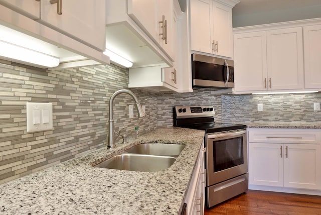 1189 N Cedar Ridge Ave, Springfield, MO 65802 - kitchen featuring appliances with stainless steel finishes, a sink, backsplash, white cabinets, and dark wood finished floors