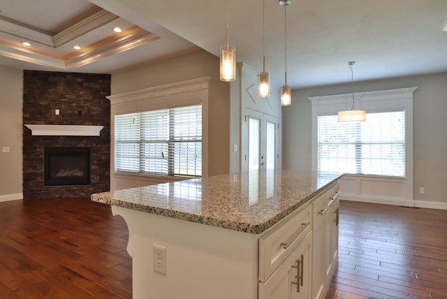 1189 N Cedar Ridge Ave, Springfield, MO 65802 - kitchen featuring dark wood finished floors, crown molding, light stone countertops, white cabinets, and hanging light fixtures