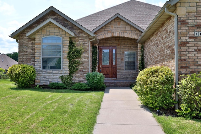 1189 N Cedar Ridge Ave, Springfield, MO 65802 - view of exterior entry with roof with shingles, brick siding, and stone siding