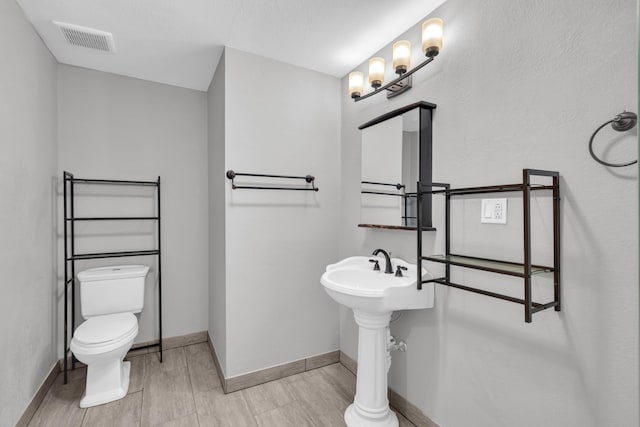 875-883 State Route T, West Plains, MO 65775 - bathroom featuring toilet, baseboards, and wood finished floors