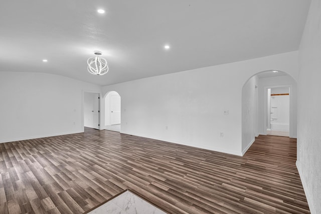 875-883 State Route T, West Plains, MO 65775 - empty room featuring arched walkways, recessed lighting, wood finished floors, vaulted ceiling, and baseboards
