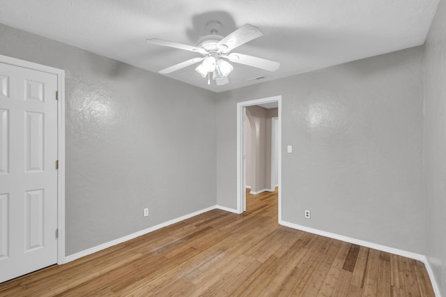 875-883 State Route T, West Plains, MO 65775 - unfurnished room featuring light wood finished floors, baseboards, ceiling fan, and a textured wall