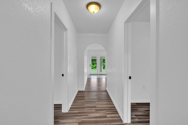 875-883 State Route T, West Plains, MO 65775 - hallway featuring arched walkways, dark wood finished floors, and baseboards