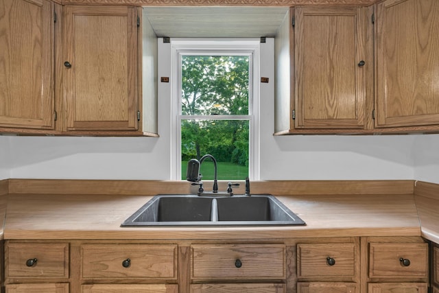 875-883 State Route T, West Plains, MO 65775 - kitchen with a sink, light countertops, and brown cabinetry