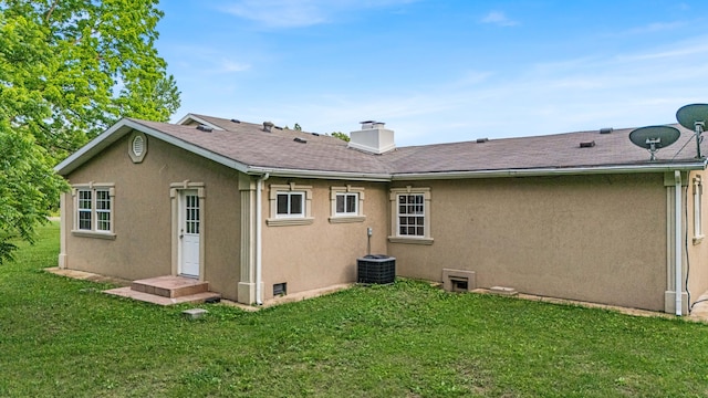 875-883 State Route T, West Plains, MO 65775 - rear view of property with a yard, stucco siding, a chimney, central AC unit, and a shingled roof