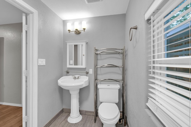 875-883 State Route T, West Plains, MO 65775 - half bath featuring wood finished floors, toilet, baseboards, and a sink