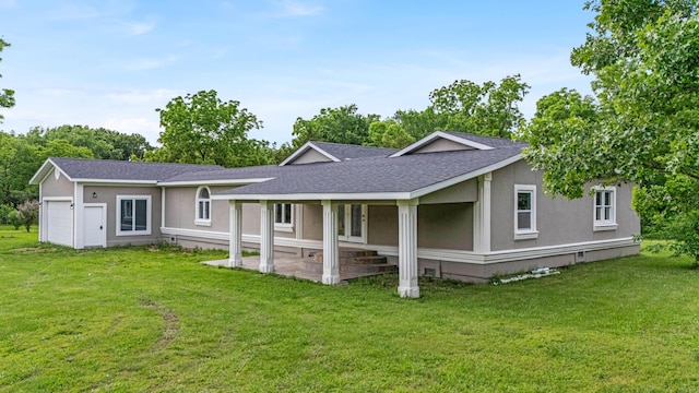 875-883 State Route T, West Plains, MO 65775 - rear view of house with roof with shingles, a yard, stucco siding, and an attached garage