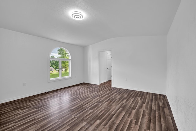 875-883 State Route T, West Plains, MO 65775 - empty room with lofted ceiling, dark wood-style floors, baseboards, and a textured ceiling
