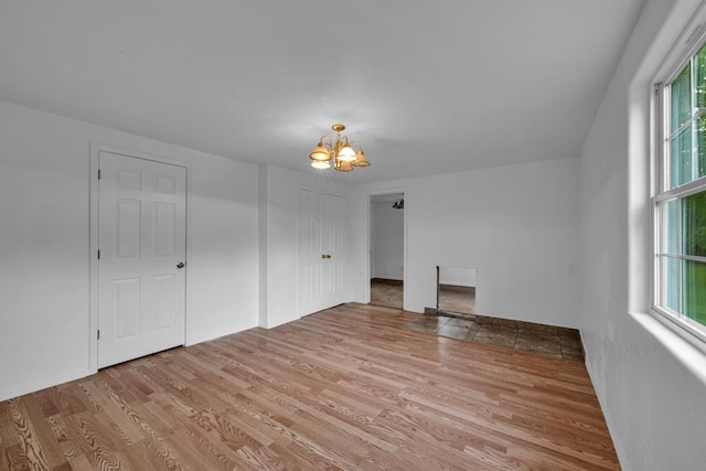 875-883 State Route T, West Plains, MO 65775 - unfurnished living room featuring a chandelier and light wood-style flooring