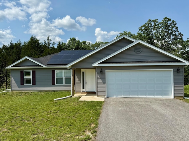 135 Bald Cypress Ct, Hollister, MO 65672 - ranch-style house with asphalt driveway, solar panels, a front lawn, and a garage