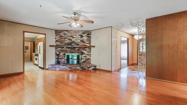 619 E Mcgee St Lot 15, Springfield, MO 65807 - unfurnished living room with hardwood / wood-style flooring, a ceiling fan, a chandelier, a fireplace, and baseboards