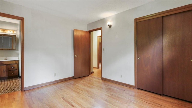 619 E Mcgee St Lot 15, Springfield, MO 65807 - unfurnished bedroom featuring light wood-style floors, baseboards, a closet, and ensuite bath