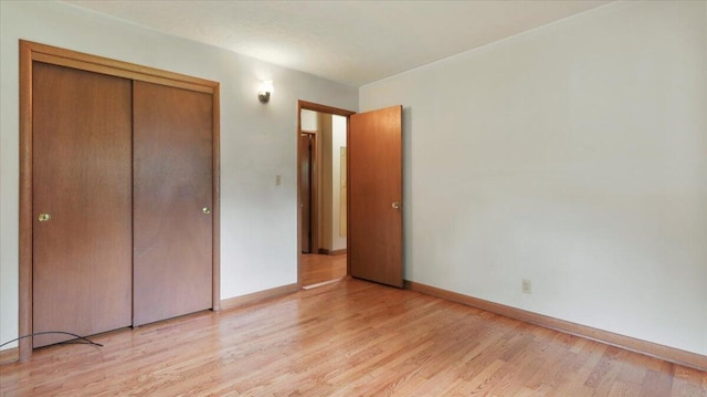 619 E Mcgee St Lot 15, Springfield, MO 65807 - unfurnished bedroom with light wood finished floors, baseboards, and a closet