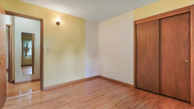 619 E Mcgee St Lot 15, Springfield, MO 65807 - unfurnished bedroom with light wood-style floors, a closet, and baseboards