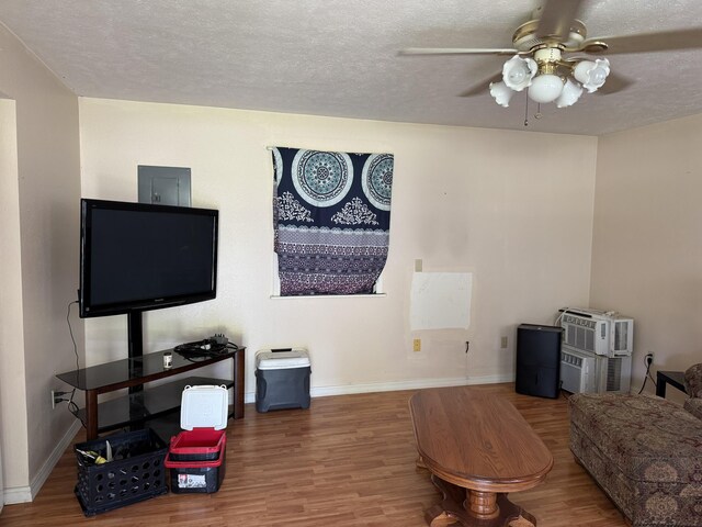 10623 State Highway O, Ava, MO 65608 - living room featuring wood finished floors, ceiling fan, baseboards, a textured ceiling, and electric panel