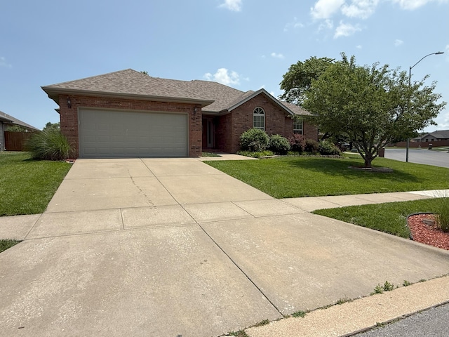 780 S Timber Ridge Dr, Nixa, MO 65714 - ranch-style home featuring a front yard, an attached garage, concrete driveway, brick siding, and roof with shingles