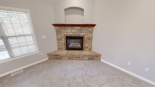 780 S Timber Ridge Dr, Nixa, MO 65714 - unfurnished living room featuring healthy amount of natural light, carpet floors, baseboards, and a stone fireplace