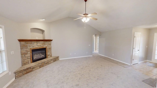 780 S Timber Ridge Dr, Nixa, MO 65714 - unfurnished living room with vaulted ceiling, ceiling fan, a stone fireplace, baseboards, and carpet