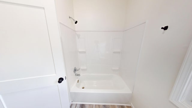 627 W Cherry St, Nevada, MO 64772 - full bathroom featuring bathing tub / shower combination and wood finished floors