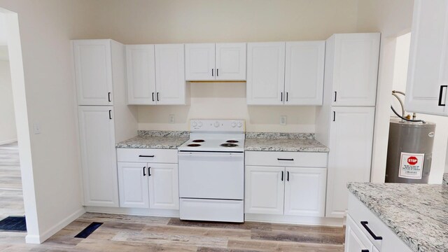 627 W Cherry St, Nevada, MO 64772 - kitchen featuring electric stove, electric water heater, white cabinetry, and light wood-style flooring