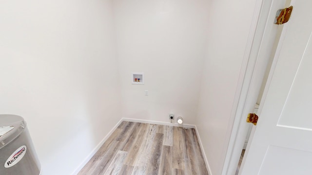 627 W Cherry St, Nevada, MO 64772 - laundry room with light wood-style floors, washer hookup, and baseboards
