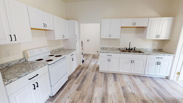 627 W Cherry St, Nevada, MO 64772 - kitchen featuring white electric range, a sink, white cabinetry, and light wood-style floors