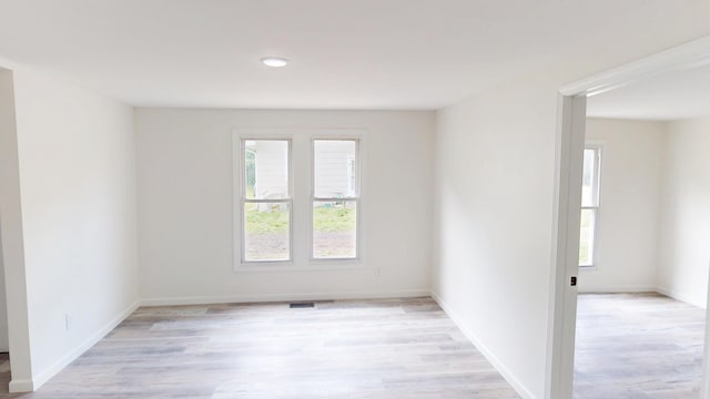 627 W Cherry St, Nevada, MO 64772 - empty room with light wood-style flooring, baseboards, and recessed lighting