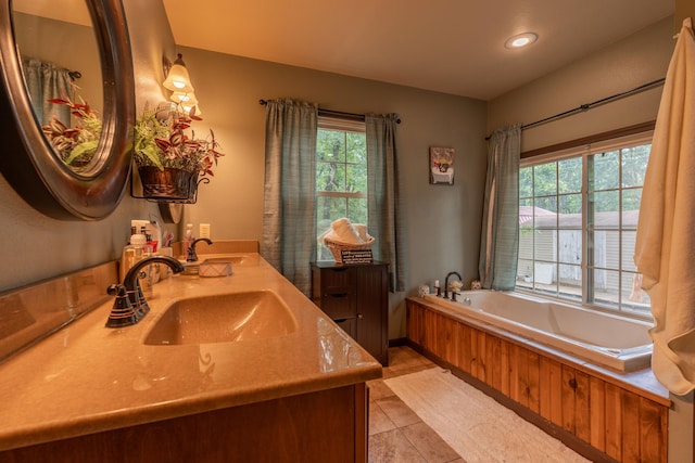 1501 NE 775th Rd, Osceola, MO 64776 - bathroom featuring double vanity, a garden tub, tile patterned flooring, recessed lighting, and baseboards