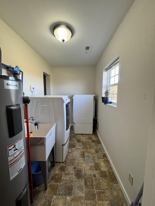3600 Steven Dr, Cabool, MO 65689 - laundry room featuring water heater, separate washer and dryer, stone finish floors, and baseboards