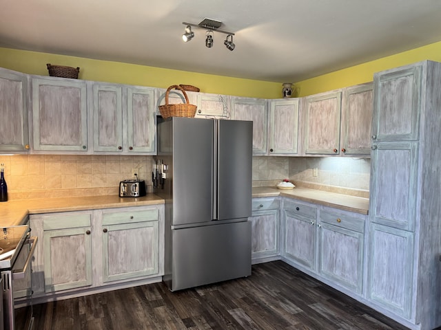 3600 Steven Dr, Cabool, MO 65689 - kitchen with freestanding refrigerator, electric stove, light countertops, tasteful backsplash, and dark wood-type flooring