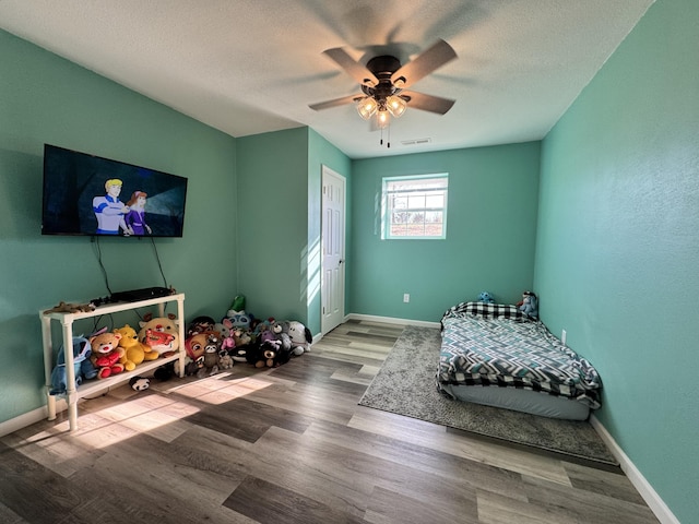 3600 Steven Dr, Cabool, MO 65689 - bedroom featuring wood finished floors, baseboards, ceiling fan, and a textured ceiling