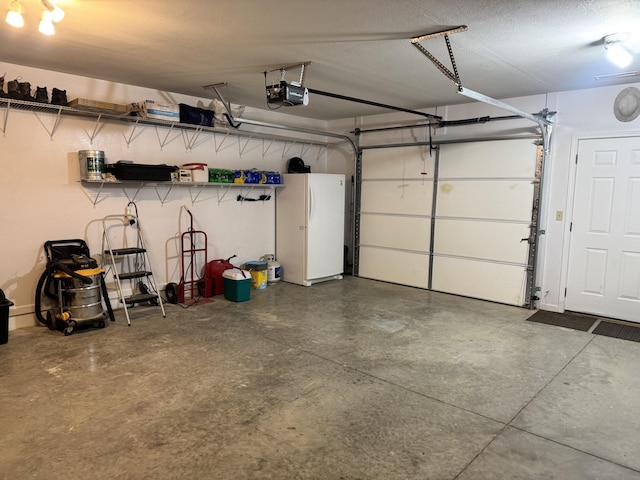 3600 Steven Dr, Cabool, MO 65689 - garage featuring a garage door opener and freestanding refrigerator