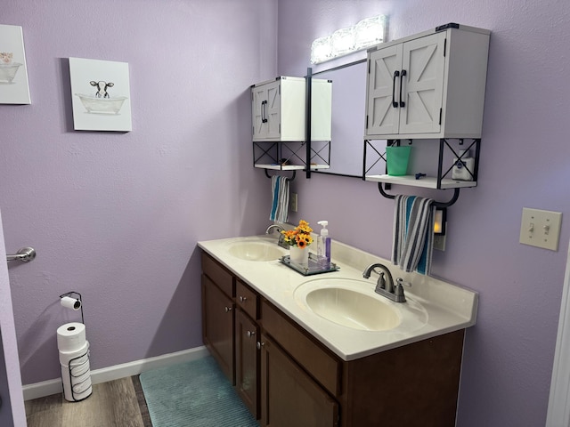 3600 Steven Dr, Cabool, MO 65689 - bathroom with wood finished floors, double vanity, and baseboards