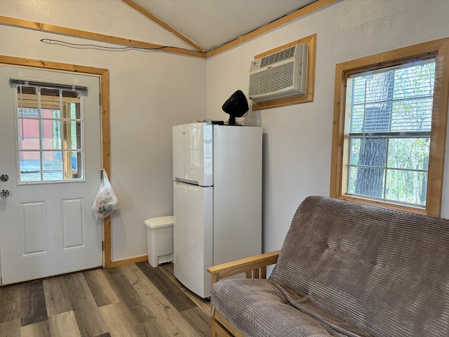 000 Steven Dr, Cabool, MO 65689 - kitchen with freestanding refrigerator, lofted ceiling, a wall mounted air conditioner, and wood finished floors