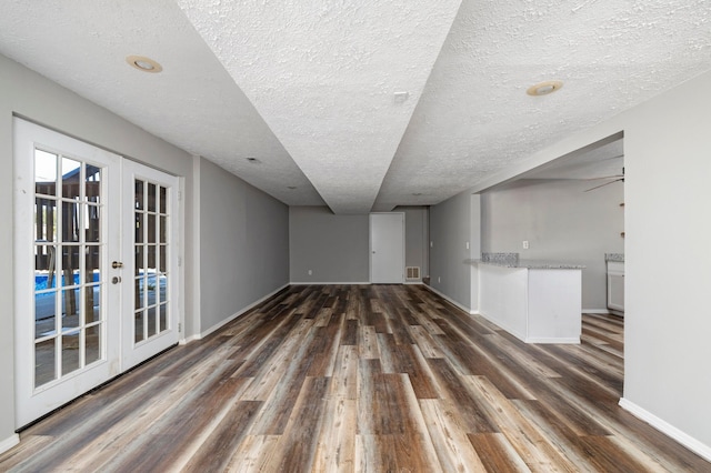 617 E SE Hills Ct, Nixa, MO 65714 - unfurnished room with wood finished floors, french doors, a textured ceiling, and baseboards