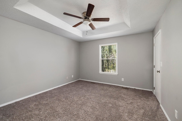 617 E SE Hills Ct, Nixa, MO 65714 - empty room featuring a raised ceiling, carpet, a textured ceiling, ceiling fan, and baseboards
