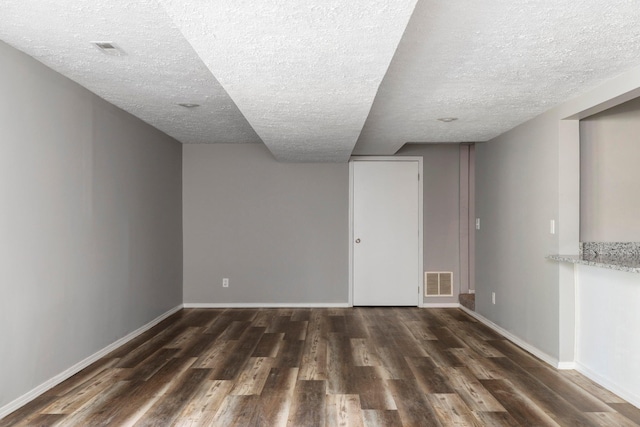 617 E SE Hills Ct, Nixa, MO 65714 - finished basement with a textured ceiling, dark wood finished floors, and baseboards