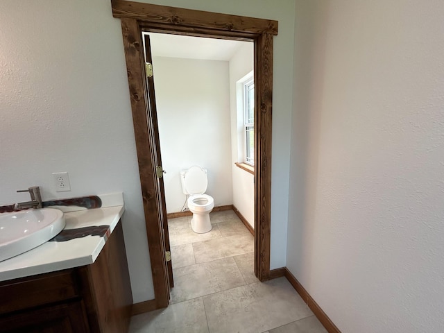 19040 Norway Rd, Neosho, MO 64850 - bathroom featuring toilet, vanity, and baseboards