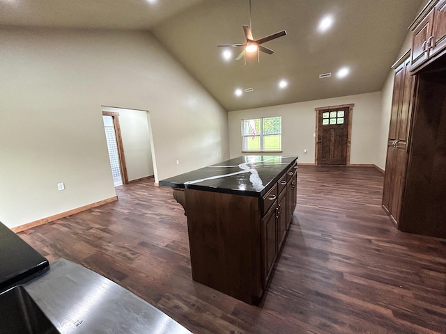 19040 Norway Rd, Neosho, MO 64850 - kitchen with dark countertops, ceiling fan, a kitchen island, high vaulted ceiling, and dark wood-style floors