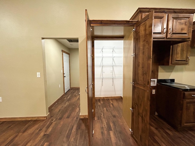 19040 Norway Rd, Neosho, MO 64850 - kitchen featuring dark wood-style flooring, dark brown cabinetry, dark countertops, and baseboards