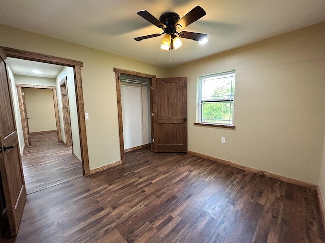 19040 Norway Rd, Neosho, MO 64850 - unfurnished bedroom featuring dark wood-type flooring, baseboards, and a ceiling fan