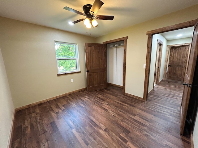 19040 Norway Rd, Neosho, MO 64850 - unfurnished bedroom with baseboards, dark wood-type flooring, ceiling fan, and a closet