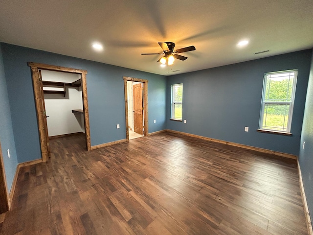 19040 Norway Rd, Neosho, MO 64850 - unfurnished bedroom with wood finished floors, recessed lighting, baseboards, a walk in closet, and ceiling fan
